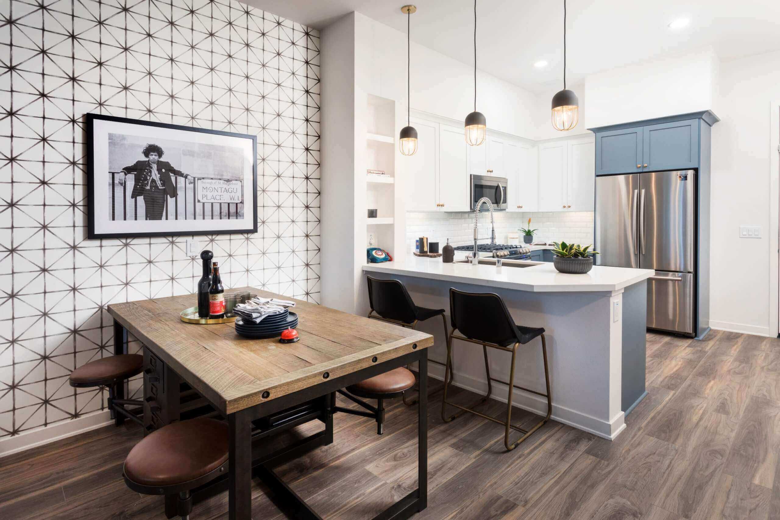 large kitchen with breakfast bar and dining area with wood floors at broadstone arden apartments